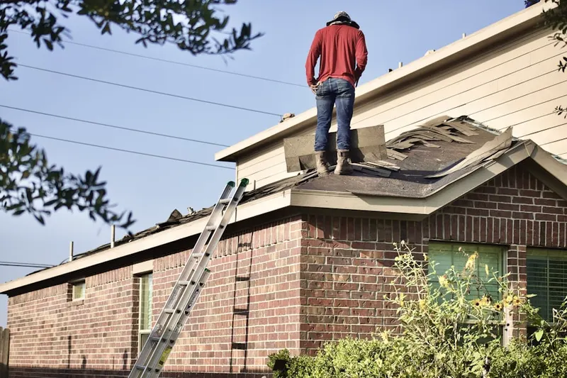 Professional roofer working on a residential roof in Westlink